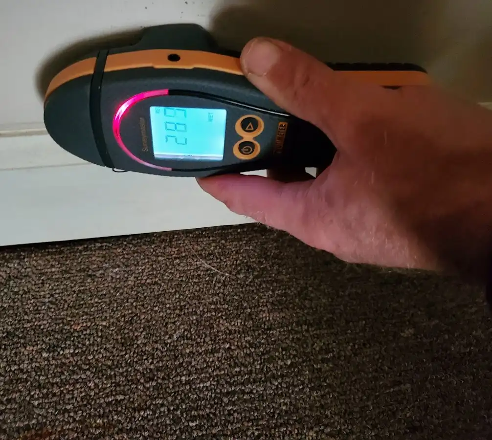 Moisture detection at baseboard during Storm Damage Restoration in Edna